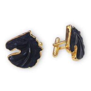 A pair of black horse head cufflinks.