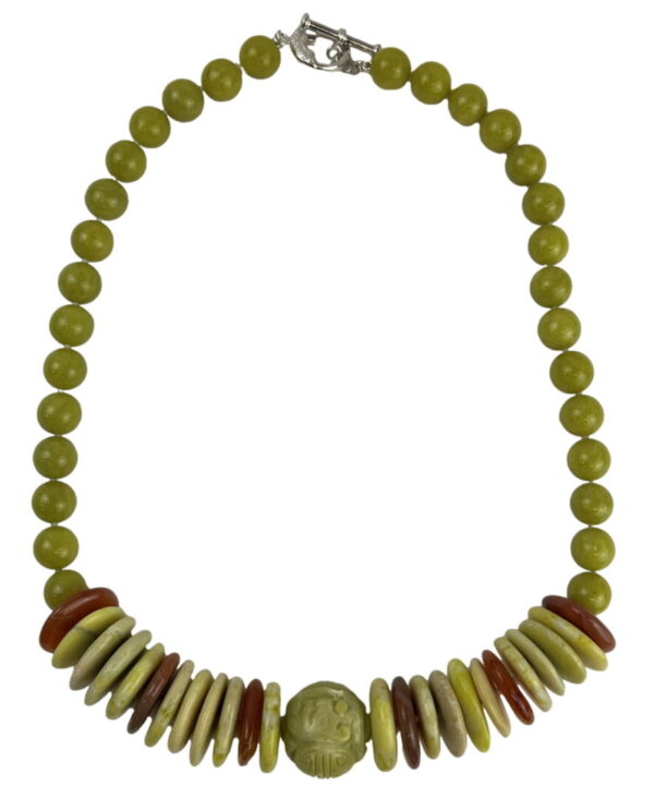 A necklace with green beads and wooden discs.