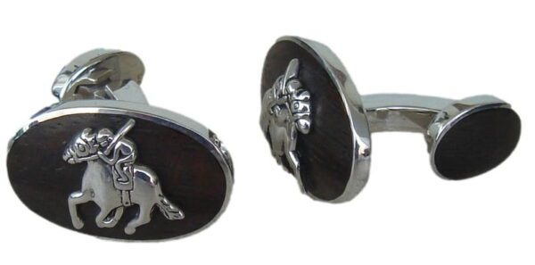 A pair of cufflinks with the image of a horse.