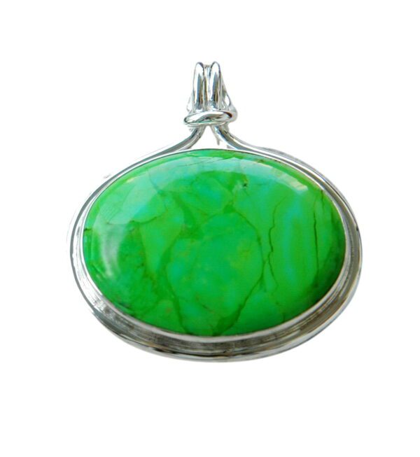 A green stone is in the middle of a silver frame.