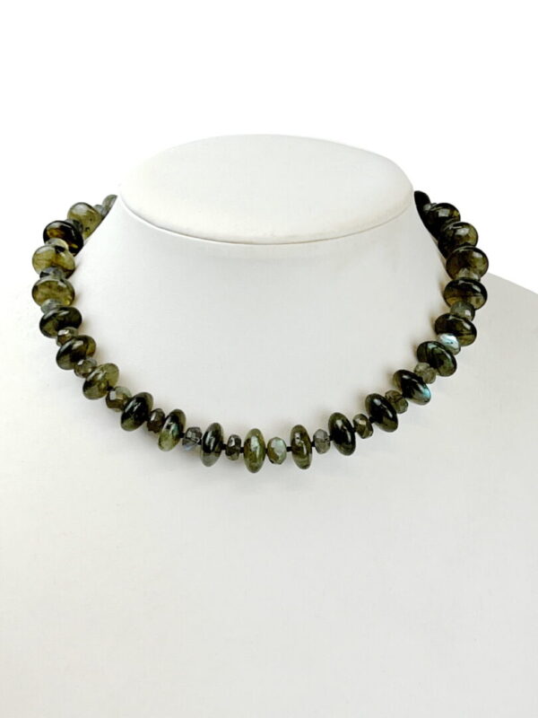 A necklace of green beads is shown on a white background.