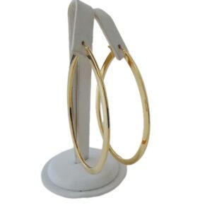 A pair of Oval & Round hoop earrings displayed on a white stand.