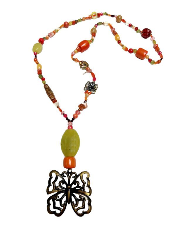 A necklace with an orange bead and a black butterfly.