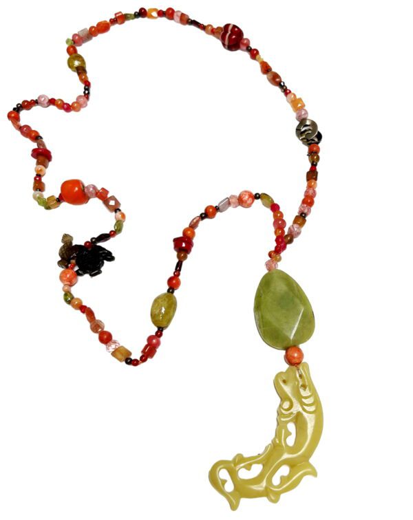 A necklace with beads and a green bead