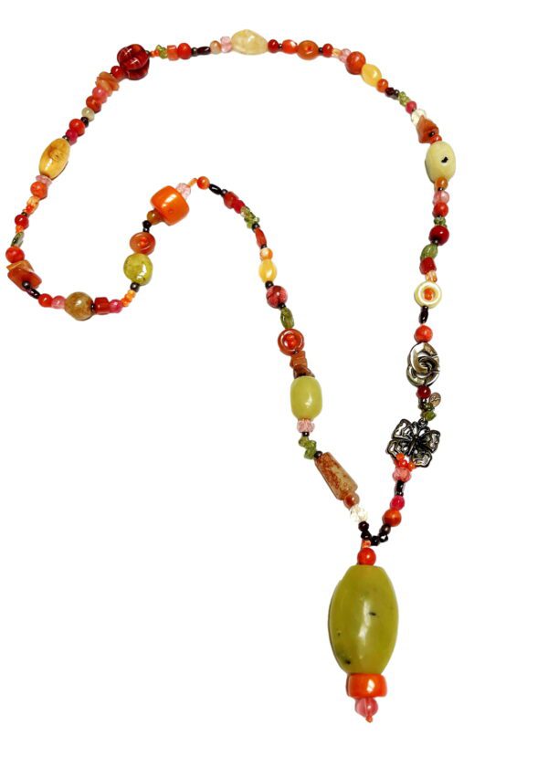 A necklace with beads and an oval shaped stone.