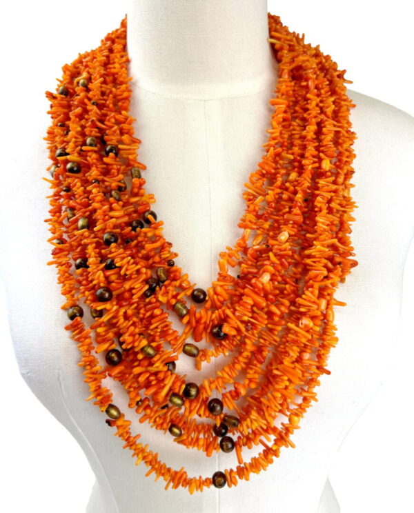 A necklace of orange beads and brown stones.