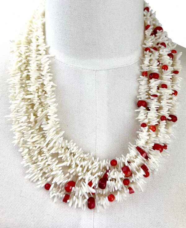 A necklace of white and red beads is shown.