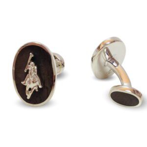 A pair of cufflinks with a horse and rider on them.