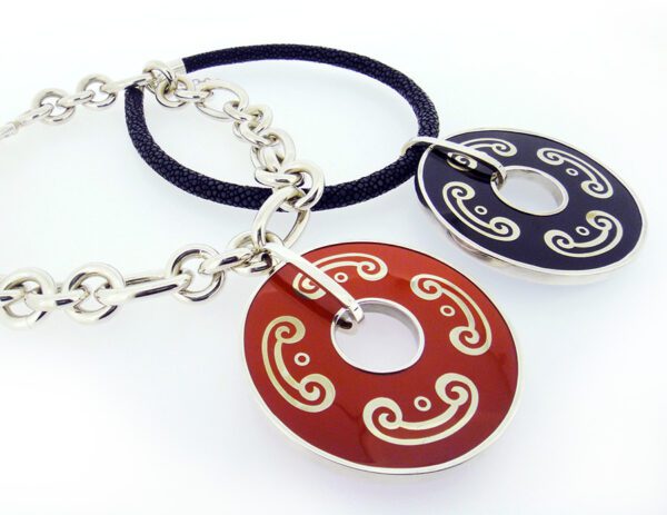 A pair of necklaces with red and blue circles.