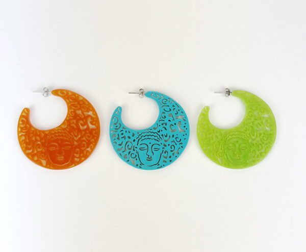 Three large, circular Buddha Resin Earrings with faces and patterns displayed side by side, in orange, blue, and green colors against a white background.