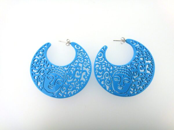 A pair of blue earrings with a face on them.