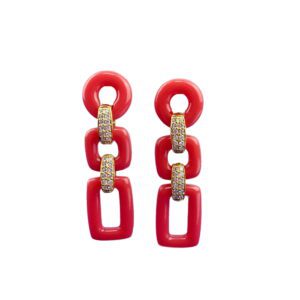 A pair of red and white earrings hanging from the side.