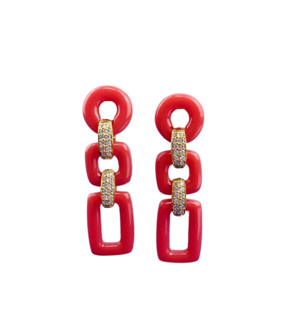 A pair of red and white earrings hanging from the side.