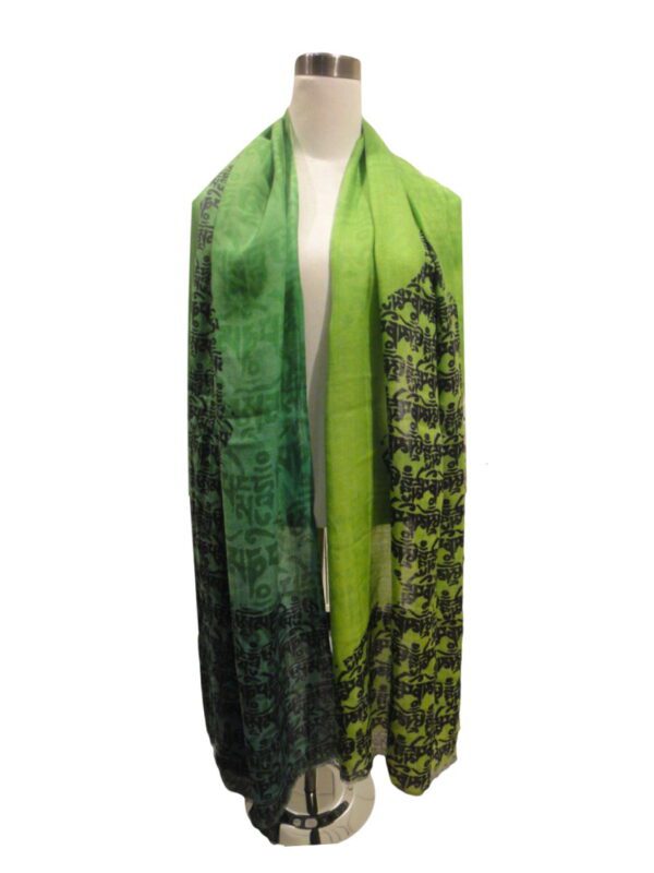 A green scarf with black and white elephants