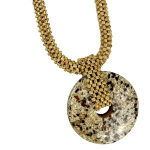 A necklace with a large round stone on it.