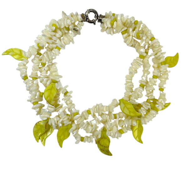 A necklace of white and green beads with leaves.