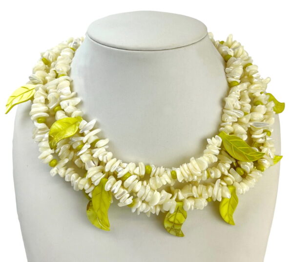 A white necklace with yellow leaves on it