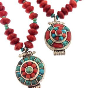 A close up of two necklaces with red and turquoise beads