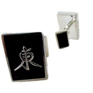 A pair of cufflinks with the symbol for chinese medicine.