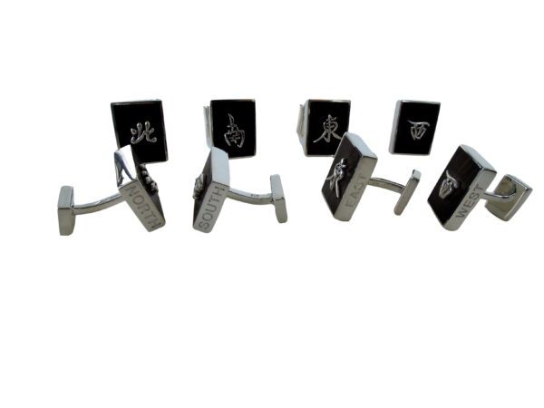 A group of four pairs of black and white cufflinks.