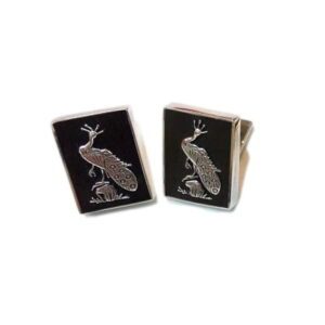 A pair of cufflinks with an image of a bird on them.