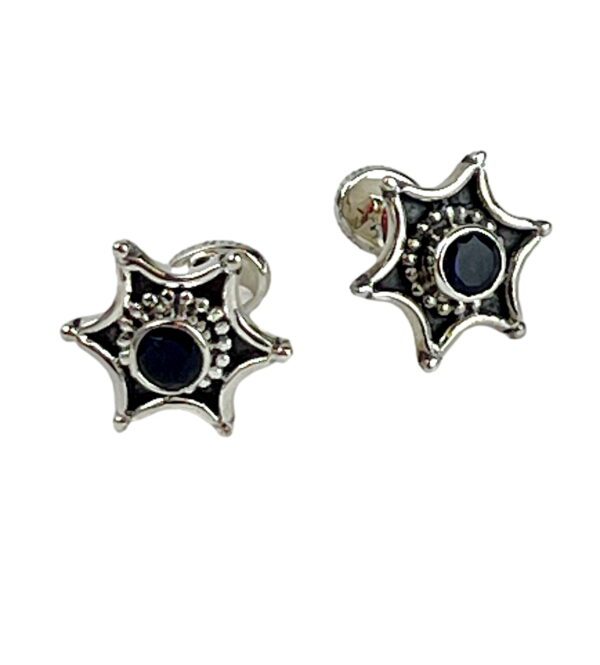 A pair of silver and black cufflinks.