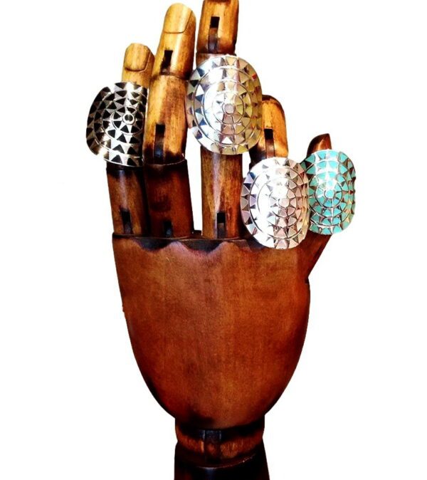 A wooden hand holding many metal objects.