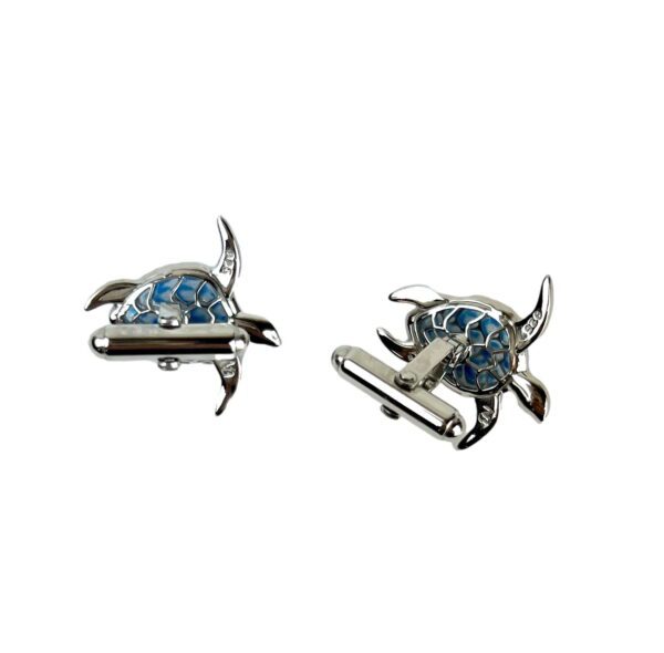 A pair of cufflinks with a turtle design.