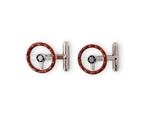 A pair of red steering wheel cufflinks.