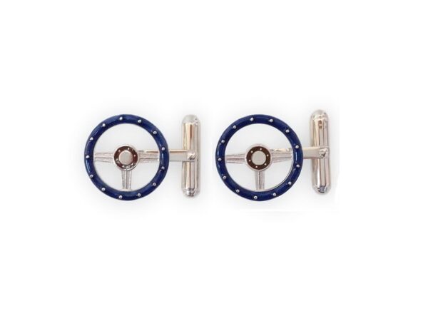 A pair of blue and silver cufflinks with a steering wheel.