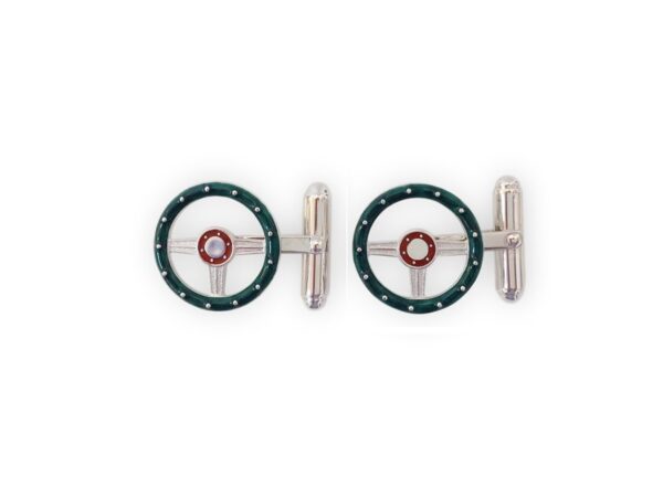 A pair of cufflinks with a green and red wheel.