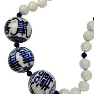 A necklace with blue and white beads on it.