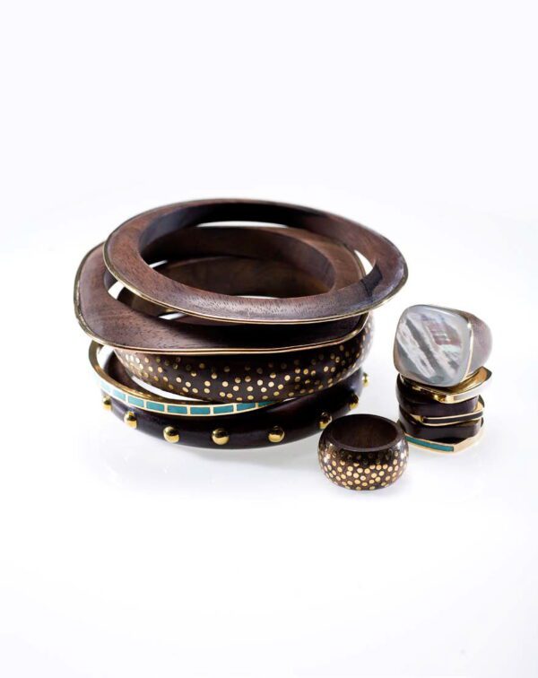 A stack of wooden bangles and bracelets on top of each other.