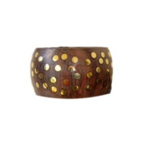 A wooden bangle with gold dots on it.