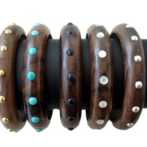 A group of wooden bracelets with different designs.