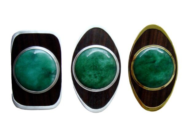 Three different colored rings with a green stone on them.