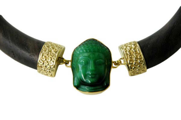 A close up of a necklace with a buddha head