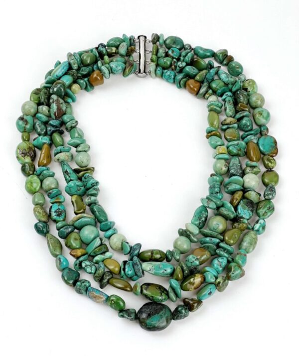 A necklace of turquoise beads and silver clasp.