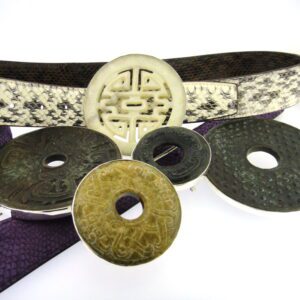 A close up of some chinese coins and a belt