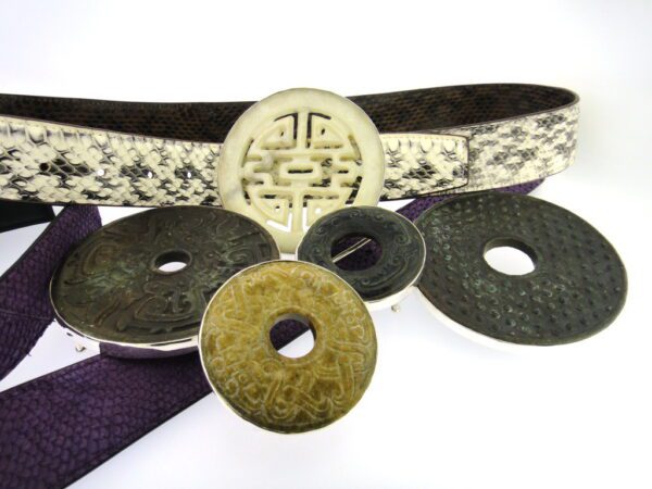 A close up of some chinese coins and a belt