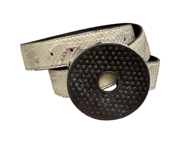 A silver belt with a black circle buckle