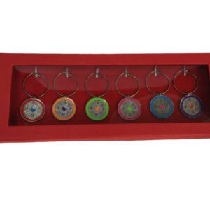 A red box with seven different colored glass discs hanging from it.