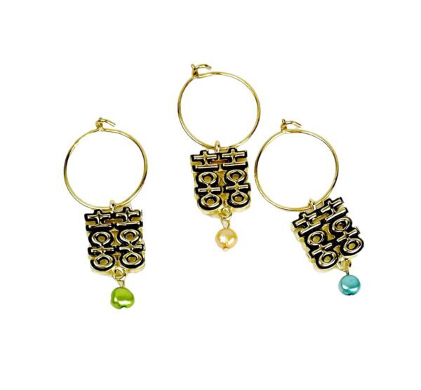 A set of three wine glass charms with gold rings.