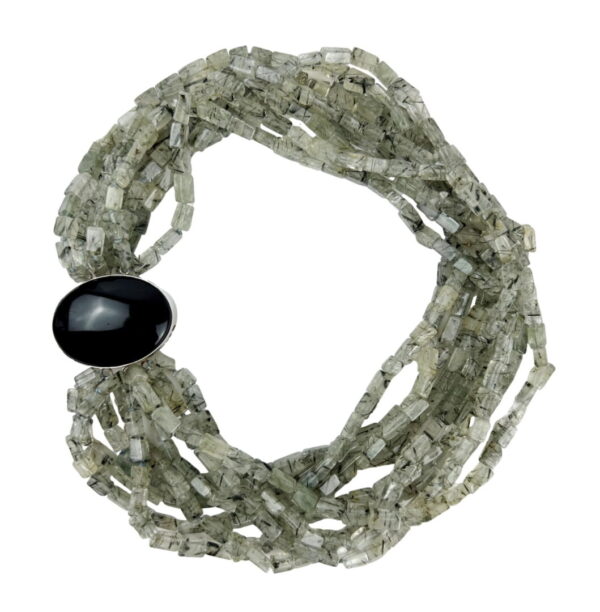A bracelet with many strands of beads and an oval black stone.