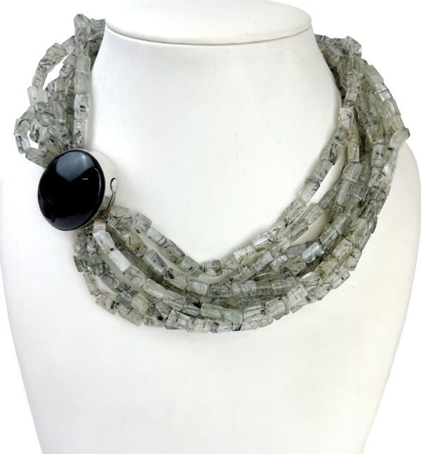 A necklace with multiple strands of gray and black beads.