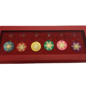 A red tray with six christmas ornaments in it.