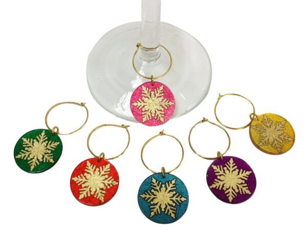 A set of six wine glass charms in the shape of stars.