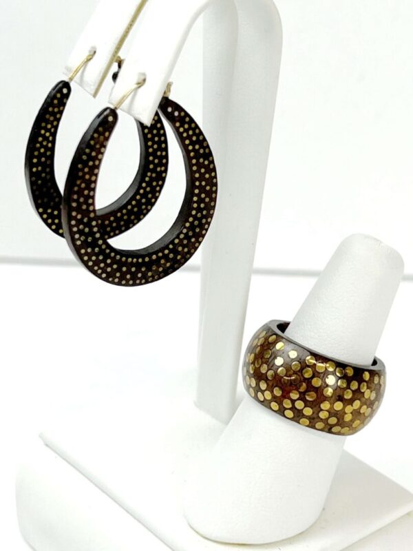 A pair of earrings and a ring on display.
