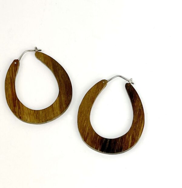 A pair of wooden earrings on a white background