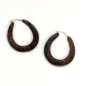 A pair of brown and black earrings on a white background
